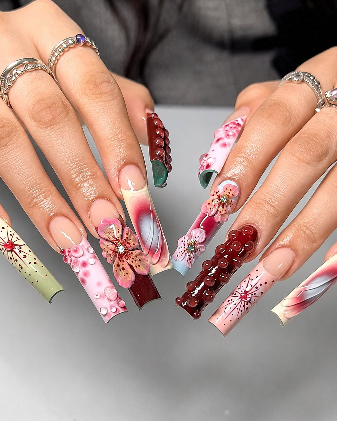 Mixed floral coffin-shaped nail set by My Royal Nails & Spa in Humble, TX